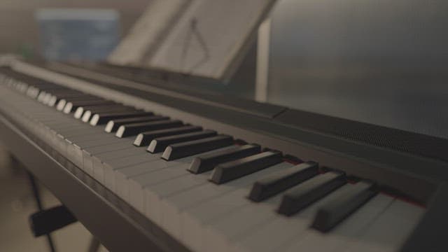 Digital Piano Keys and Sheet Music