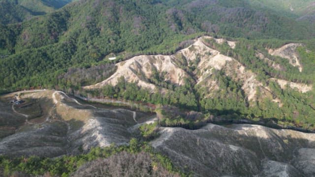 Expansive mountainous landscape with forested valleys in daytime