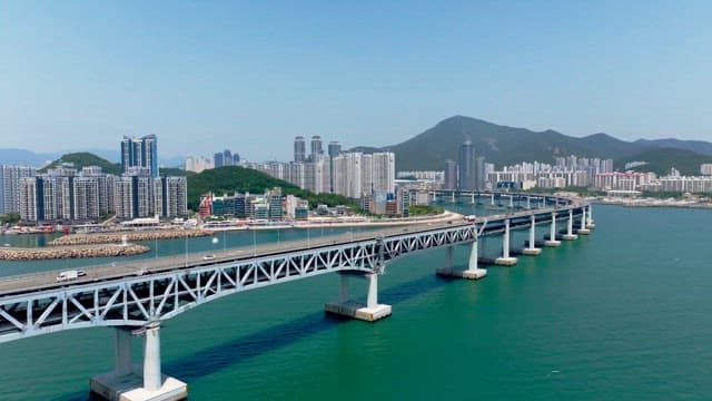 View of a densely built coastal area and bridge on a sunny day