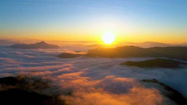 Sunrise Over Cloud-Covered Mountains