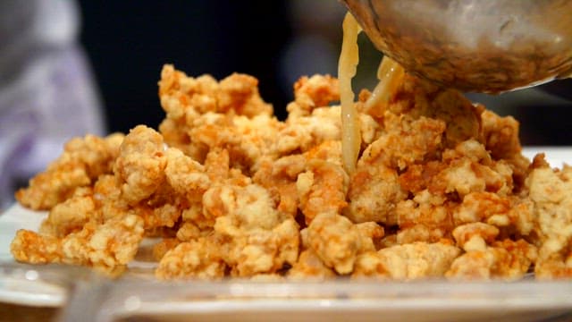 Sweet and sour pork, made by pouring sauce over crispy fried food