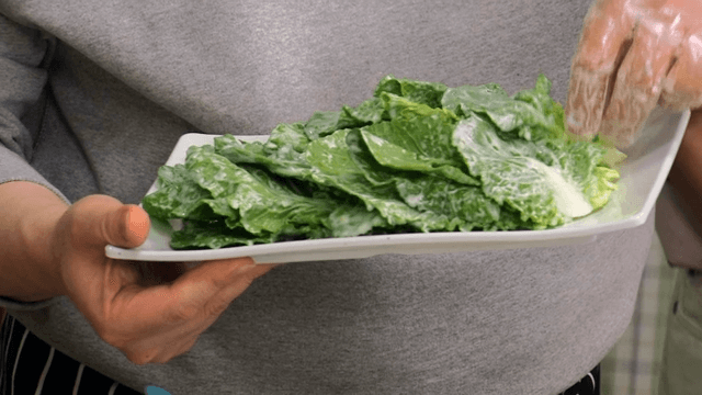 Person preparing a plate of delicious spring cabbage salad