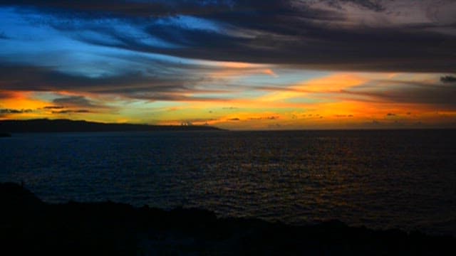 Fiery Sunset Over a Tranquil Sea