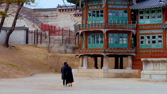 Couple walking near a traditional Korean building