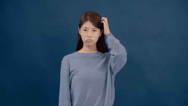 Long haired woman scratching her head with a confused expression