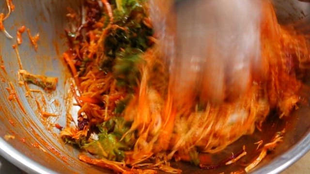 Bibim noodles made by mixing vegetables with spicy sauce