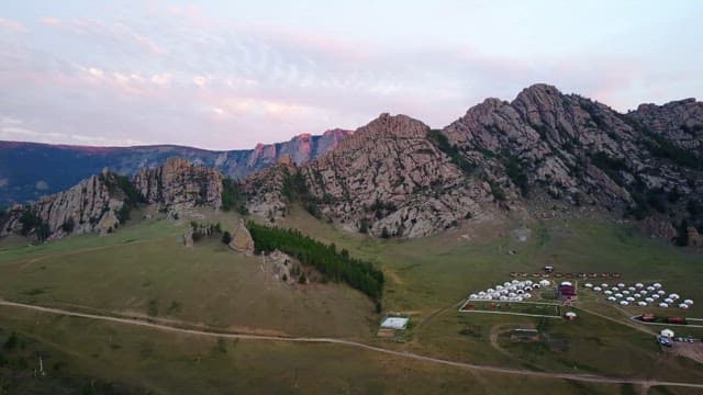Mountain landscape with yurts at sunrise