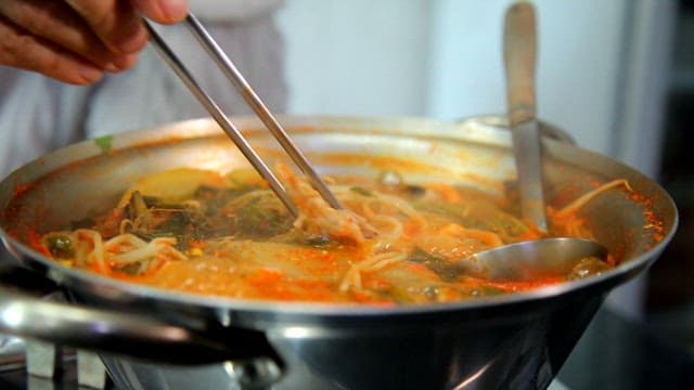 Puffer fish slices of kimchi stew boiling in a pot