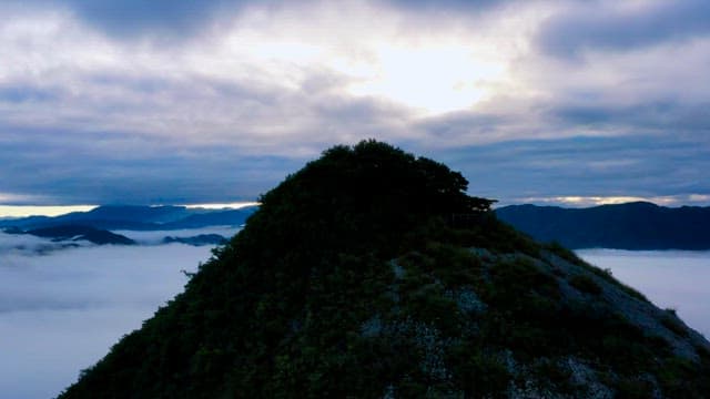 Mountain Peak Above Sea of Clouds at Dawn