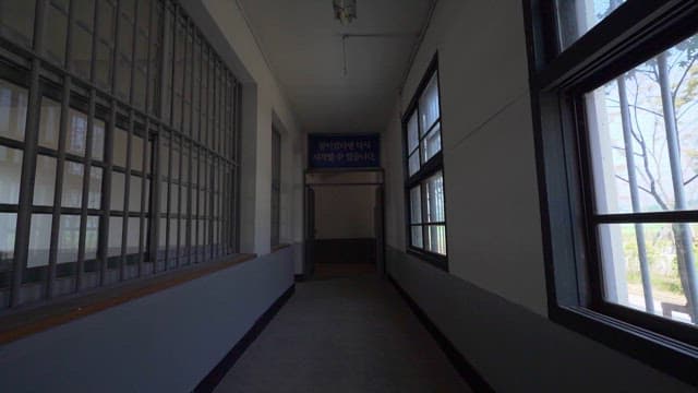 Prison Hallway with Barred Windows