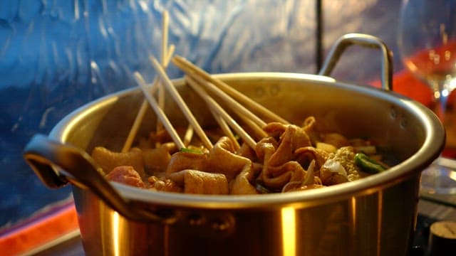 Fish cake soup inside the tent is boiling deliciously in a pot