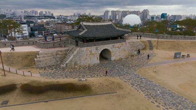 Hwaseong Fortress, traditional Korean gate with a cityscape in the background