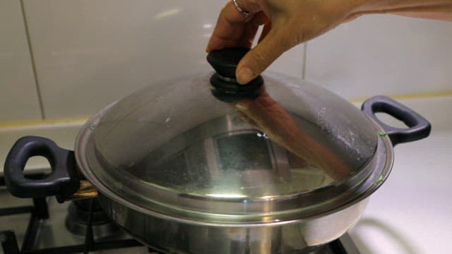 Green vegetable cooked in a pot on the stove