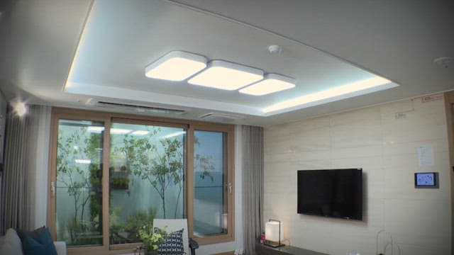 Modern living room interior with large window and TV