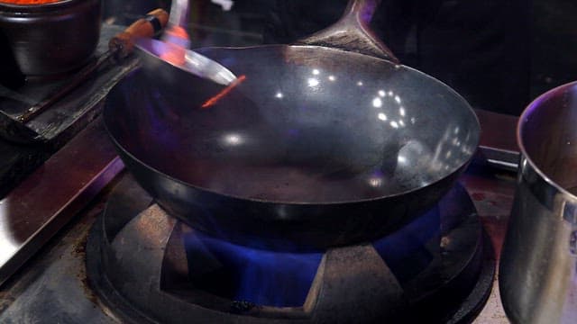 Stir-frying in a flaming wok at high heat