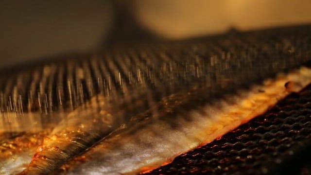 Fish grilling on a hot barbecue grill