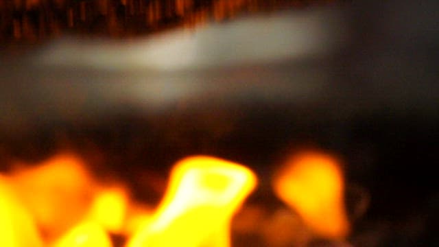 Seasoned pork intestines sizzling on a grill