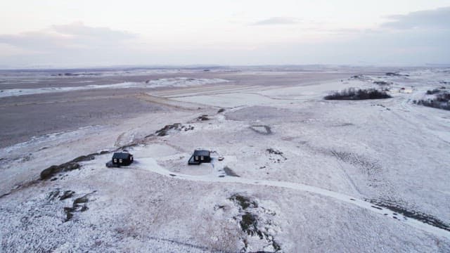 Snow-covered landscape with cabins