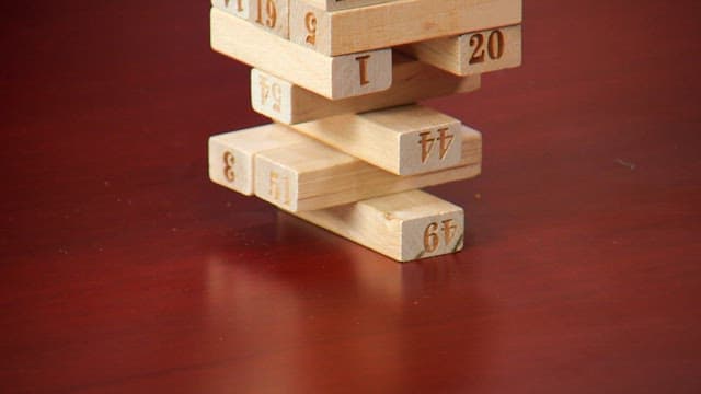 Jenga blocks stacked precariously on a table