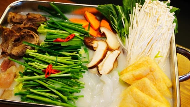 Fresh vegetables and meat prepared in a pot for tendon hotpot cooking