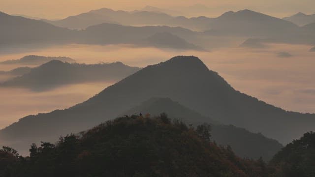 Serene Sunrise atop Misty Mountains