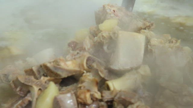 Boiling bone soup with steam rising