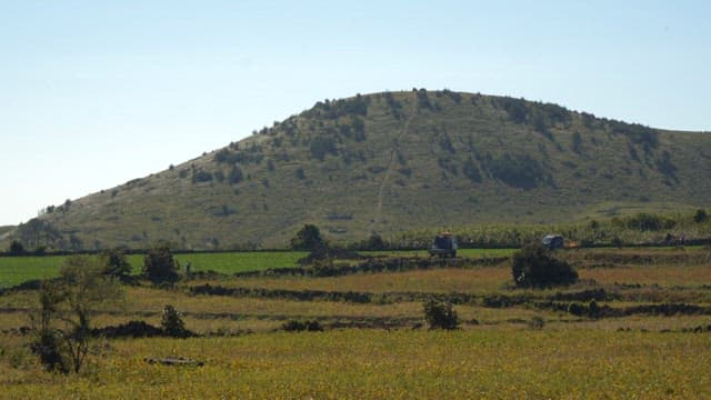 Field spread out beneath a volcanic mountain on Jeju Island on a clear day