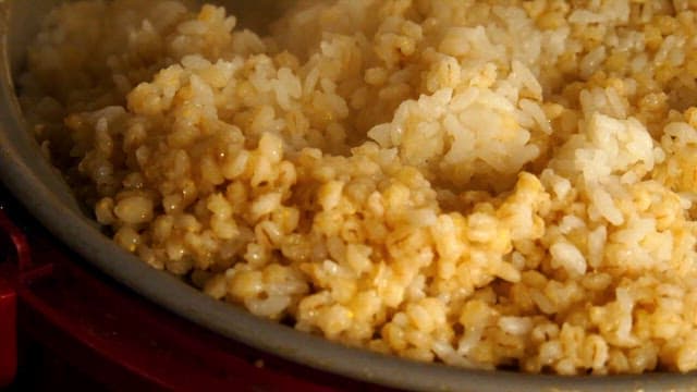 Freshly cooked barley rice with steam