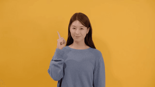 Long haired woman raising index finger after realizing something