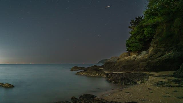 Tranquil night beach with starry sky
