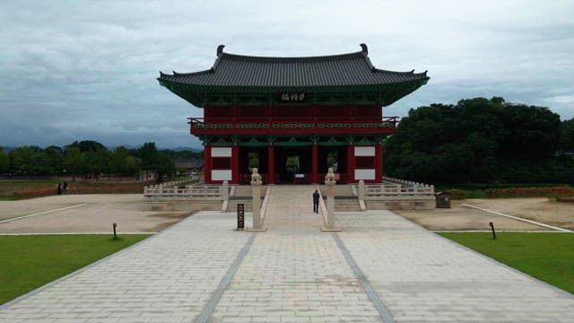 Traditional Korean gate with a person walking