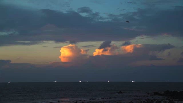 Serene Seascape at Twilight with Illuminated Clouds