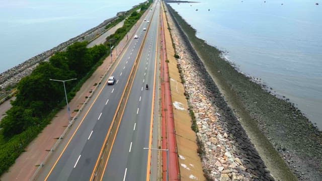 Coastal highway with cars and ocean view