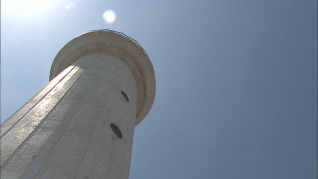 Lighthouse pillar standing under the bright sun