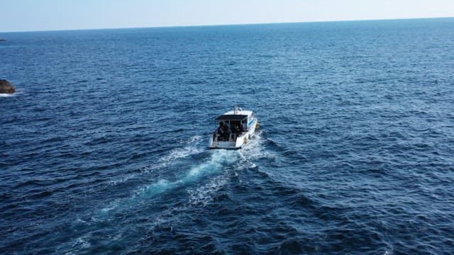 Boats Navigating Around Majestic Rocky Islands