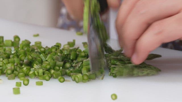 Cutting Fresh Asparagus on a Cutting Board