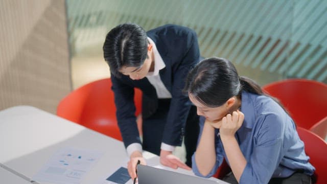 Two colleagues discussing a report