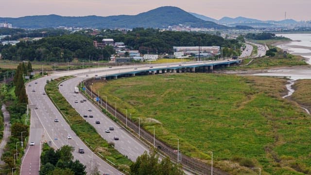 Highway wtih Green Space with Glowing Twilight