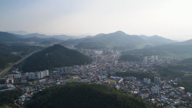 City surrounded by mountains and greenery