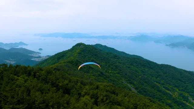 Paragliding Over Scenic Mountainous Landscape by the Sea