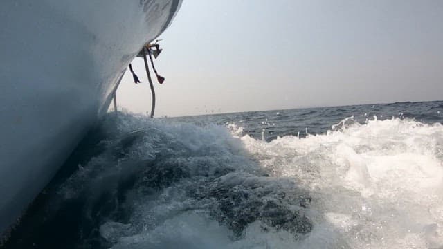 Boat cutting through ocean waves