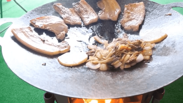 Pork belly and vegetables grilled outdoors