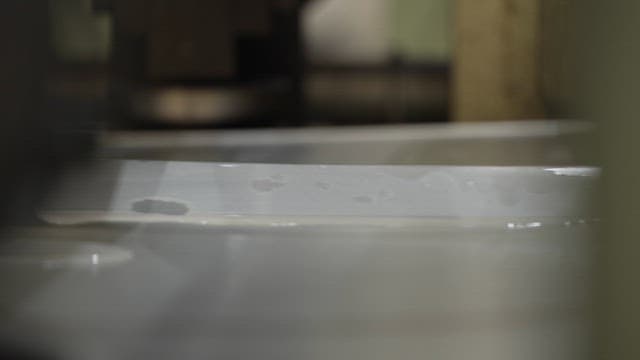 Metal sheet with water droplets in a factory