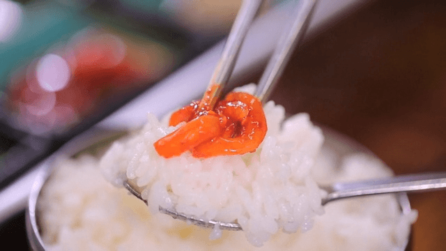 Spoonful of rice with salted small octopus