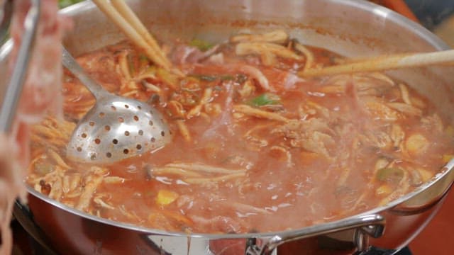 Cooking a delicious and spicy hot pot dish with various ingredients