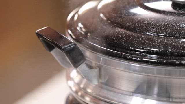Steam rising from a steamer on the stove