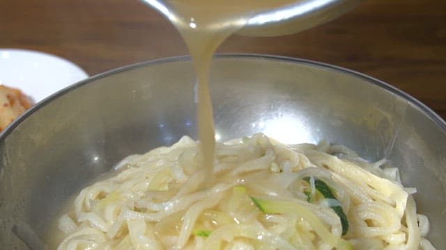 Warm kalguksu noodles served with broth