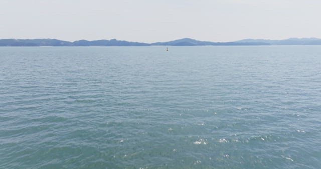 Vast ocean with distant mountains