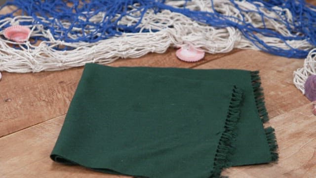 Basket of fresh seaweed on a wooden table.