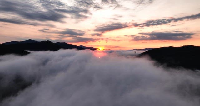 Sunrise over misty mountains